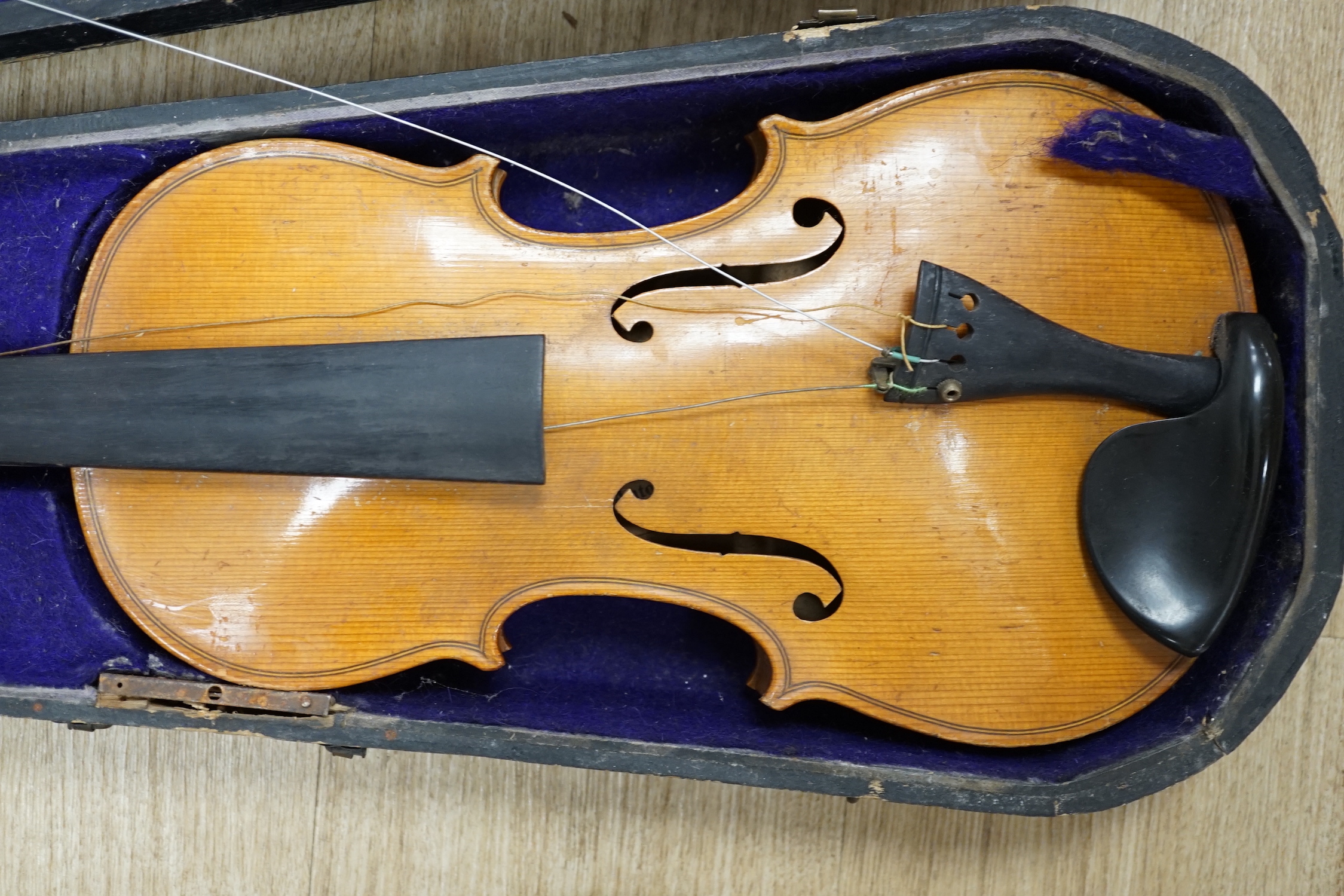 A wooden cased early 20th century Czechoslovakian student’s violin, bears ‘Copy of Stradivarius’ label, body length, 35.5cm, without bow